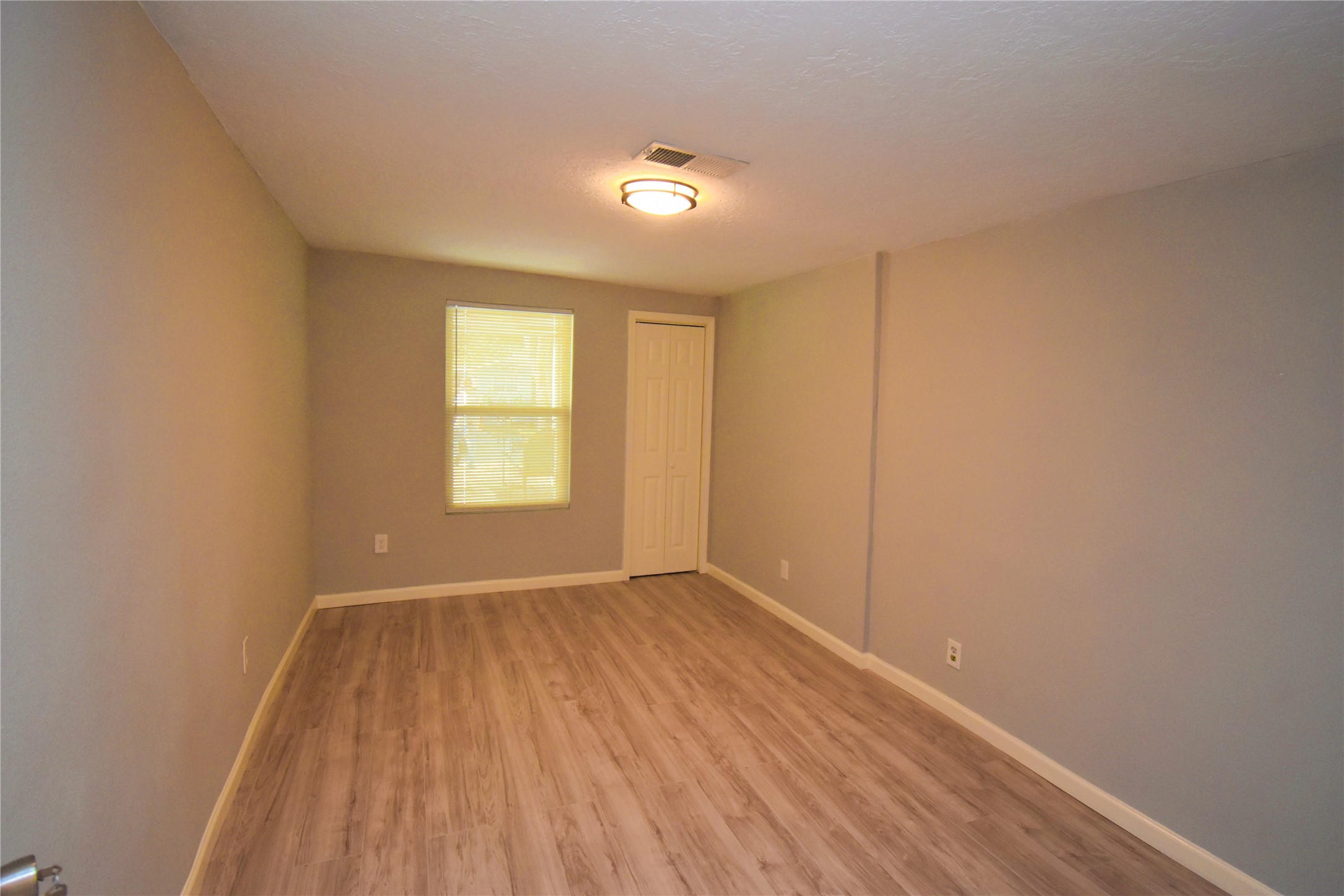 1115 Georgina Street Rosenberg, TX 77471 - Photo 14 of 17 a view of empty room with wooden floor and fan