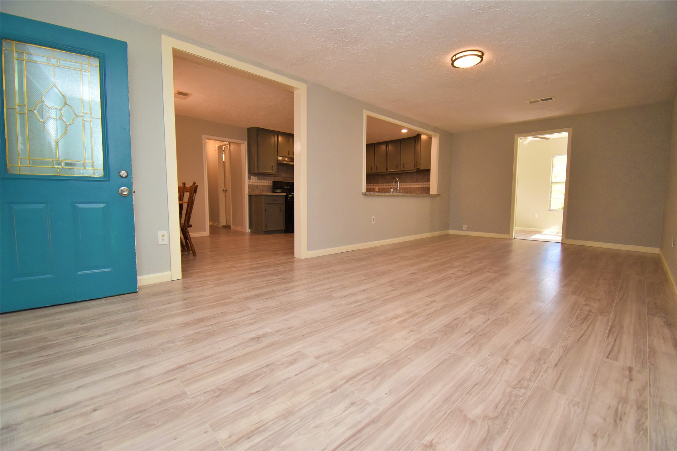 1115 Georgina Street Rosenberg, TX 77471 - Photo 3 of 17 an empty room with wooden floor and windows