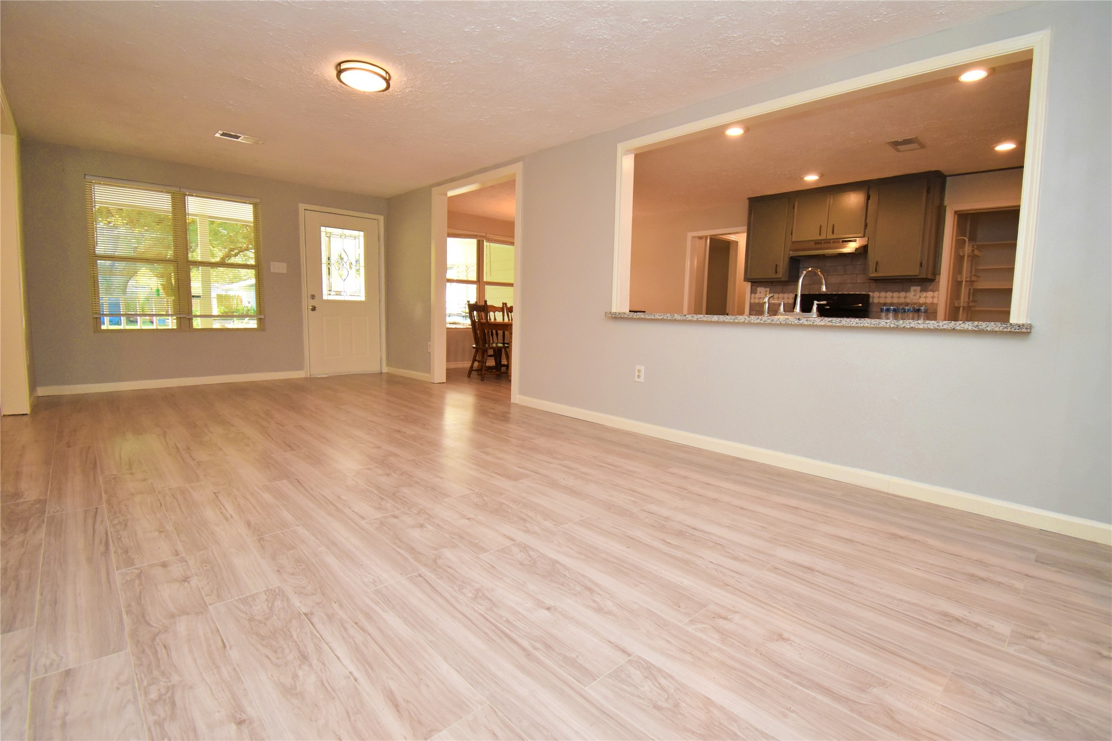 1115 Georgina Street Rosenberg, TX 77471 - Photo 4 of 17 an empty room with wooden floor and windows