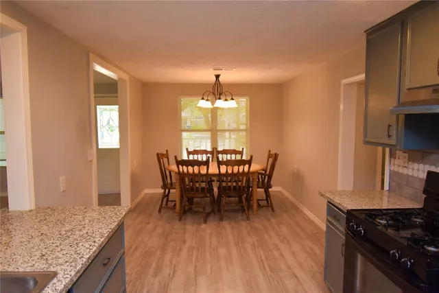 a dining room with furniture and window