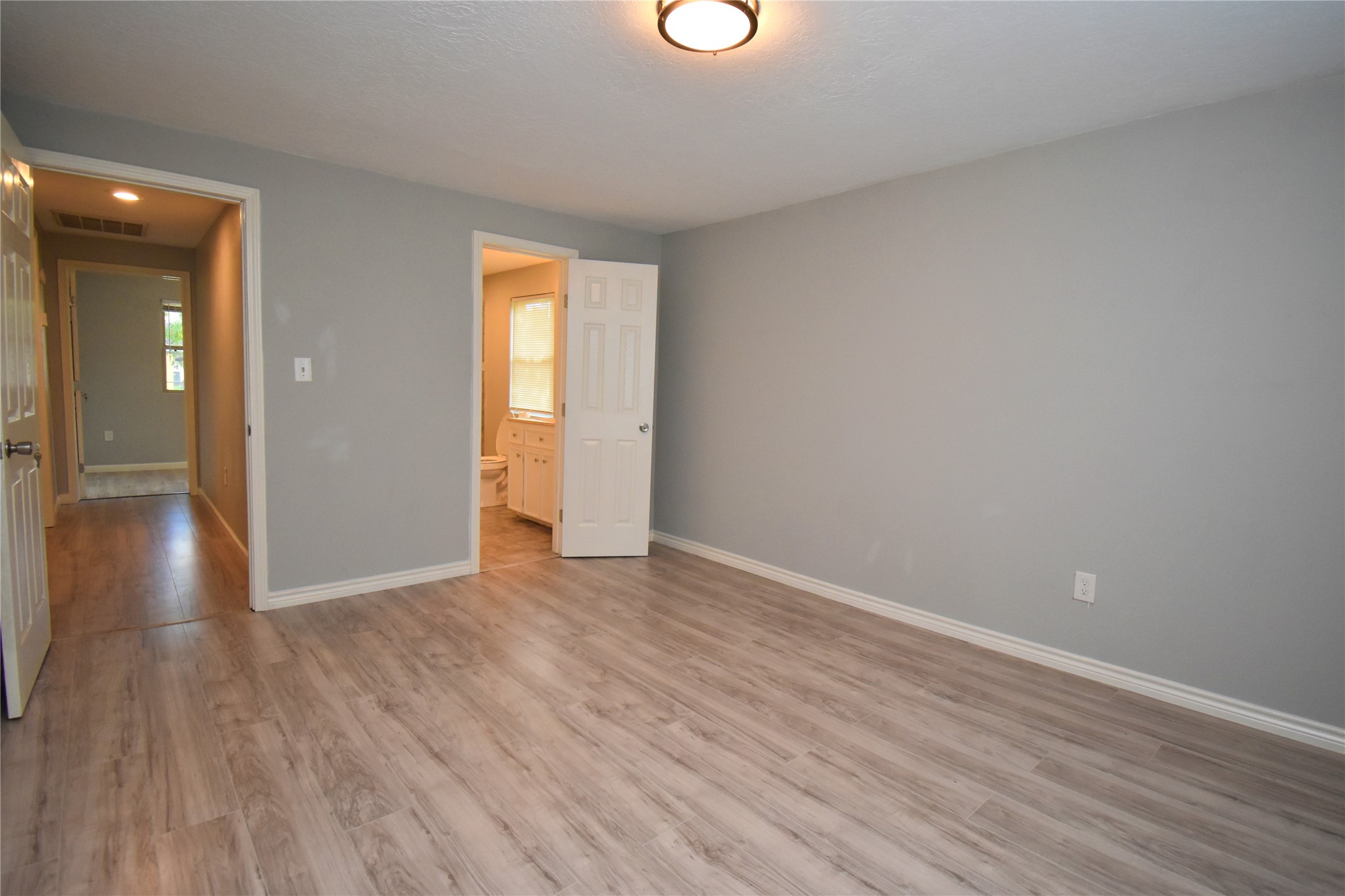 1115 Georgina Street Rosenberg, TX 77471 - Photo 10 of 17 a view of an empty room with wooden floor and a window