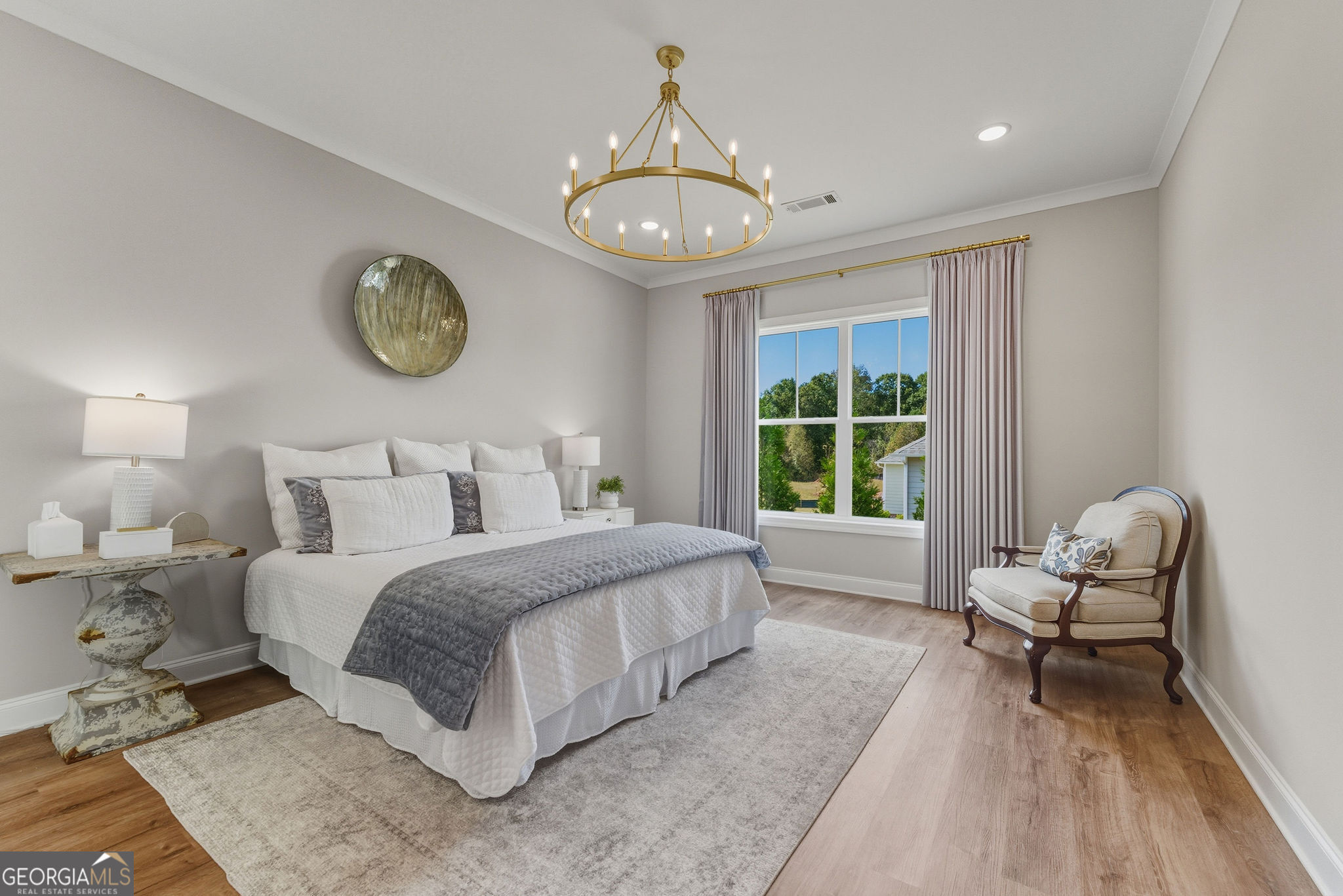 1140 Providence Loop Greensboro, GA 30642 - Photo 19 of 28 a spacious bedroom with a bed and a chair