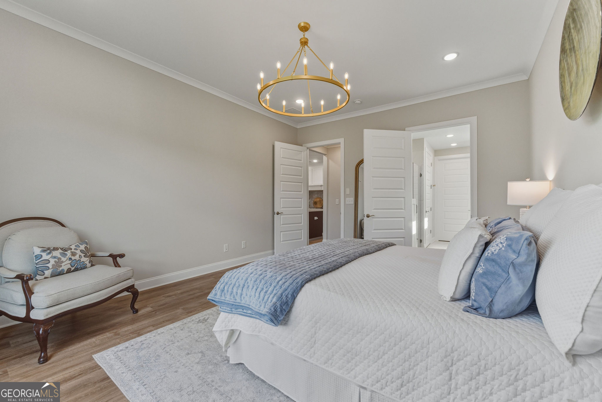 1140 Providence Loop Greensboro, GA 30642 - Photo 20 of 28 a bedroom with a bed and a chandelier