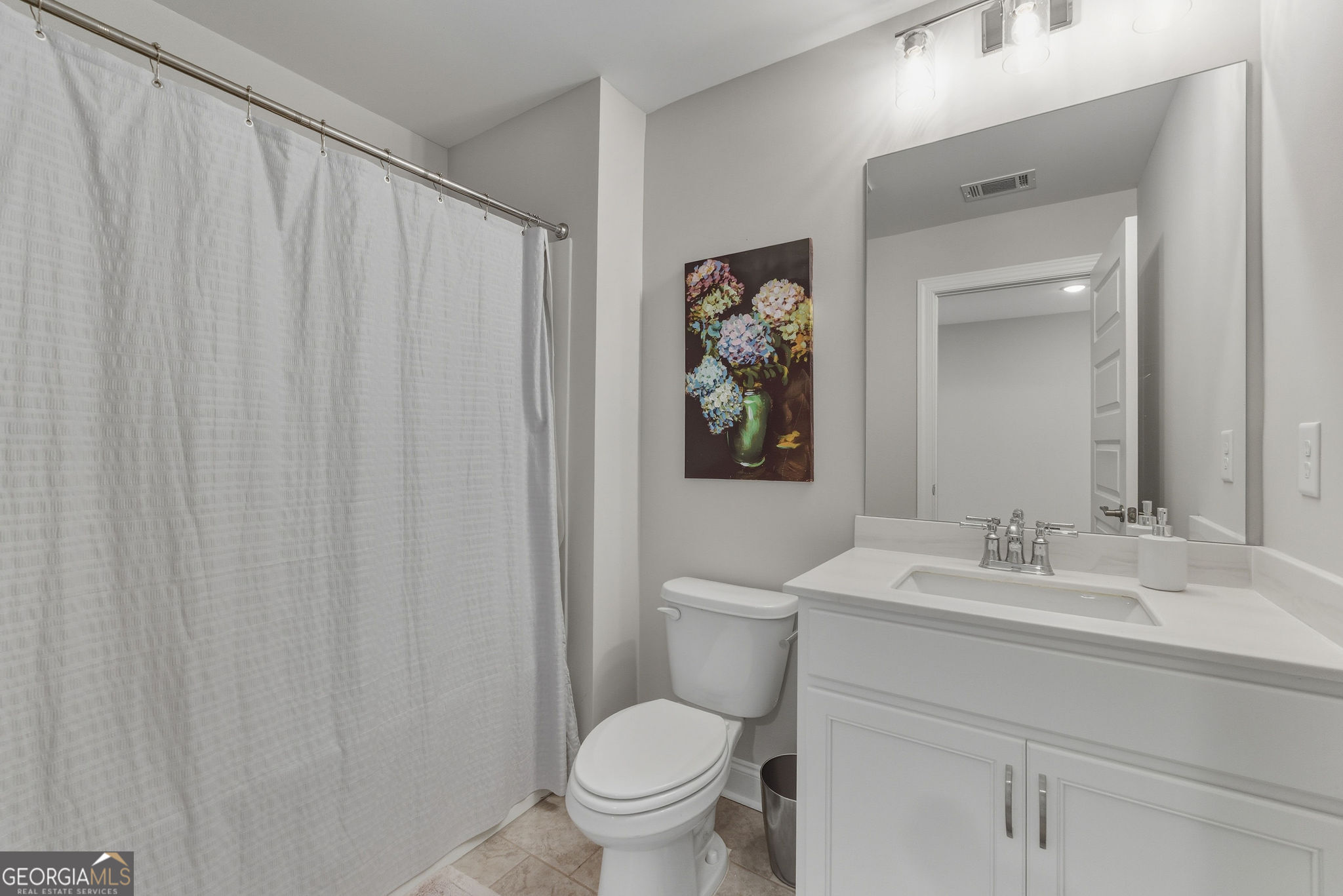 1140 Providence Loop Greensboro, GA 30642 - Photo 25 of 28 a bathroom with a toilet sink and mirror