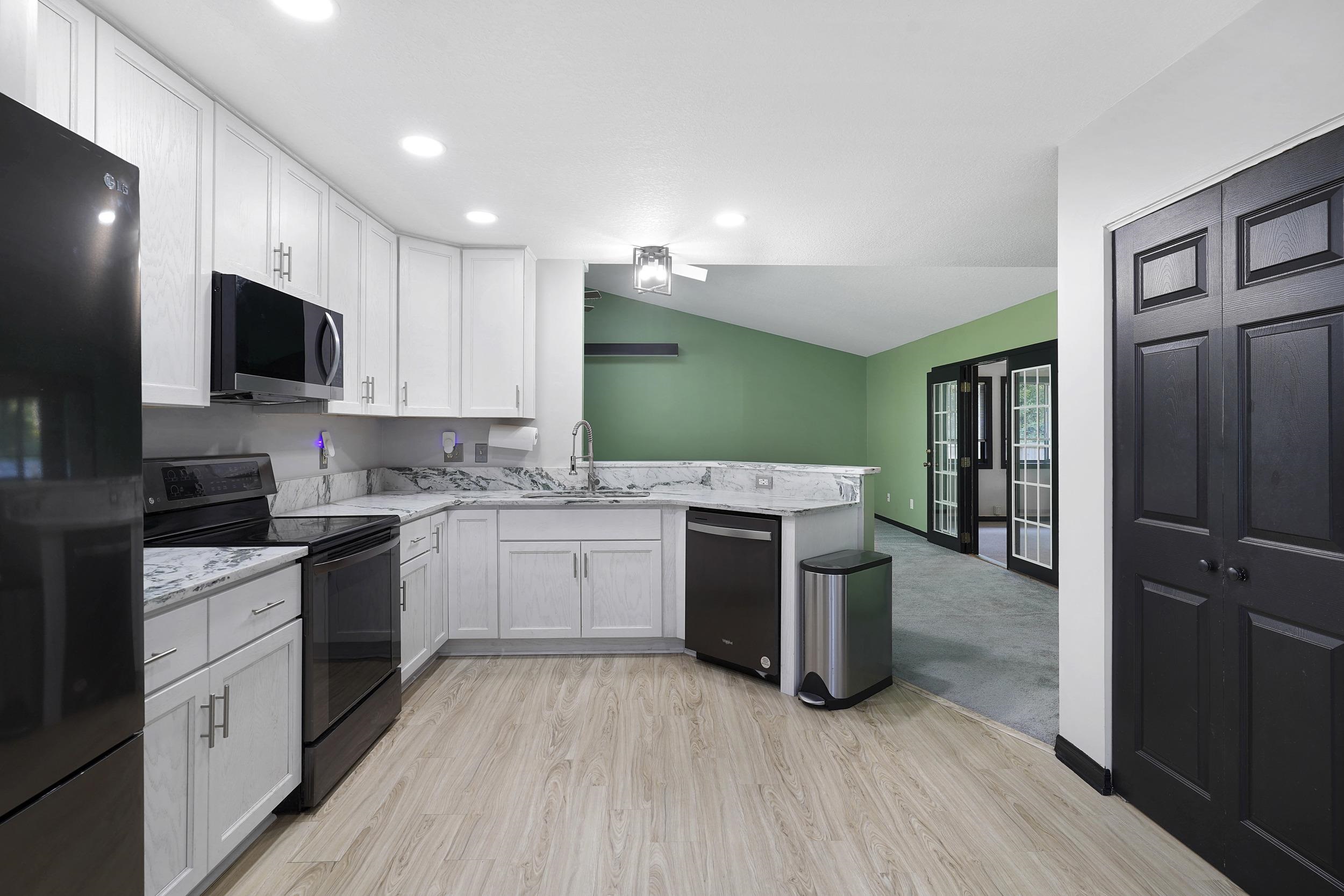 607 West Bianca Circle St. Augustine, FL 32086 - Photo 14 of 35 a kitchen with a sink a counter top space stainless steel appliances and cabinets