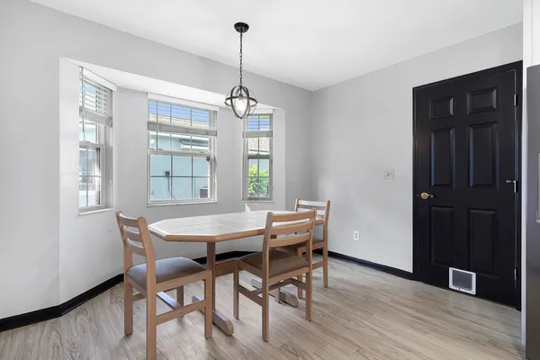 a view of a dining room with furniture window and wooden floor