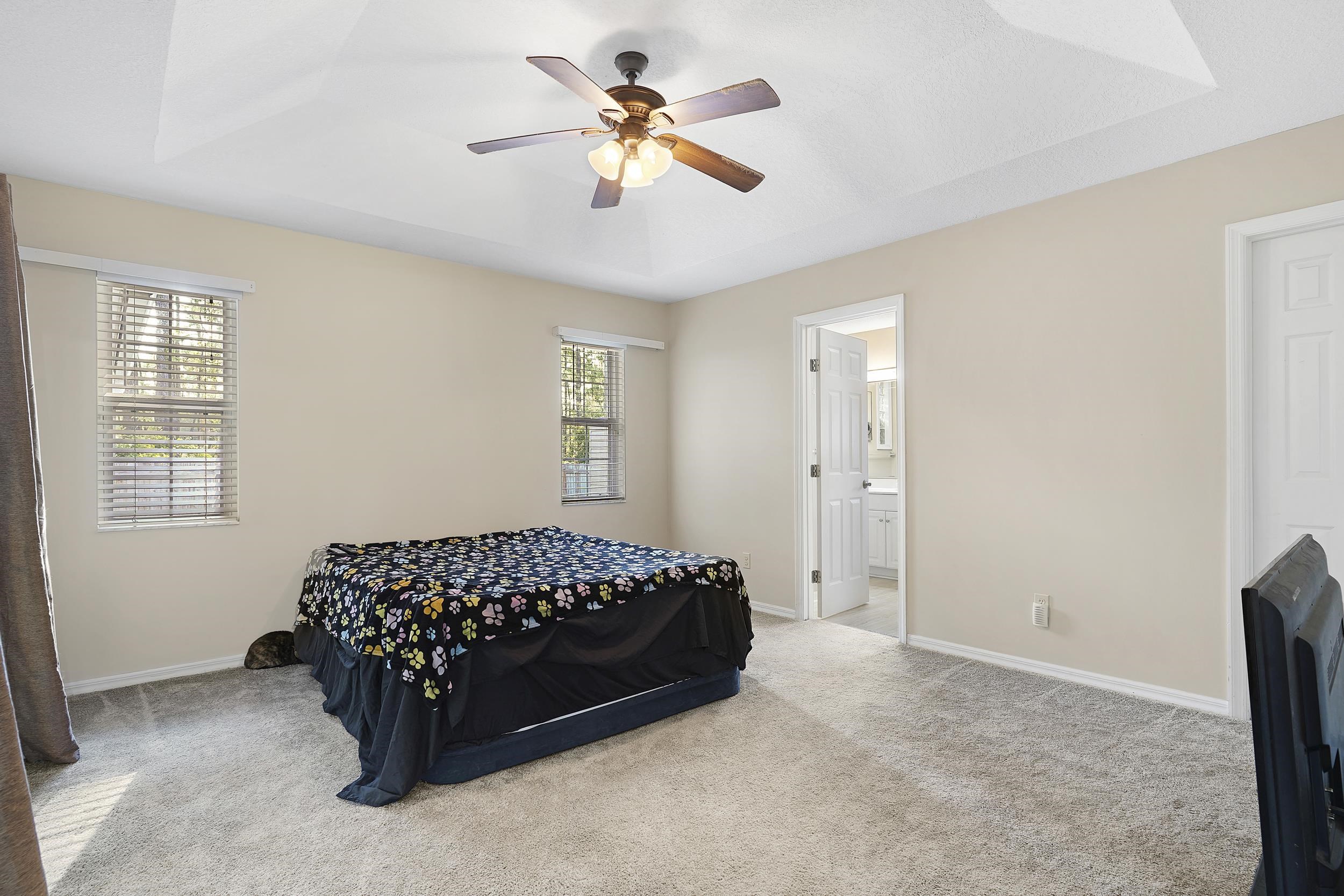 607 West Bianca Circle St. Augustine, FL 32086 - Photo 16 of 35 a bedroom with a bed and a ceiling fan