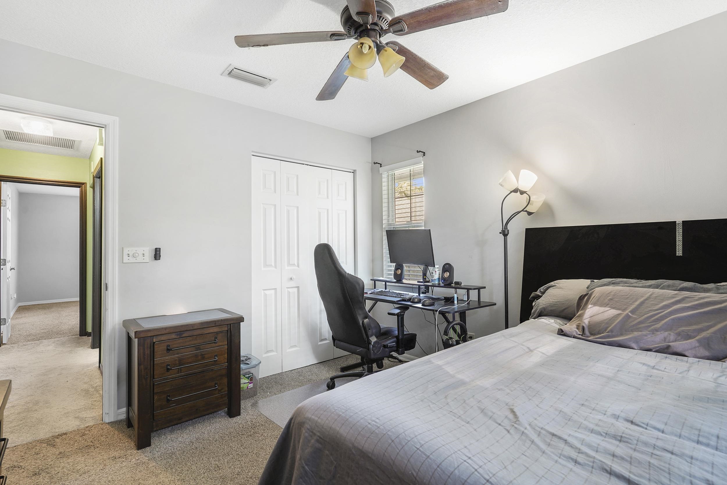 607 West Bianca Circle St. Augustine, FL 32086 - Photo 25 of 35 a bedroom with a bed and a chandelier
