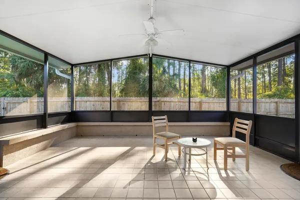 a living room with furniture and a floor to ceiling window