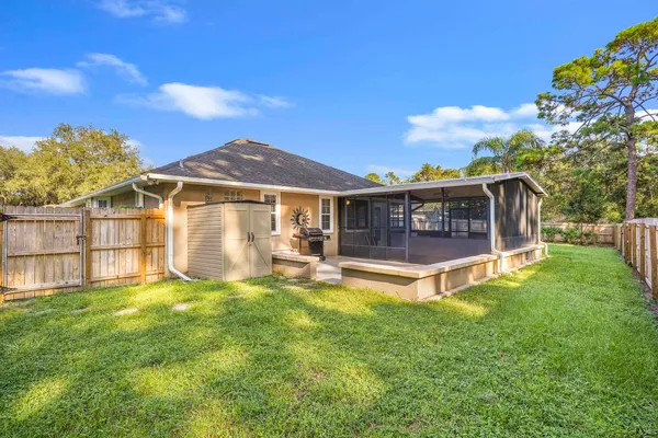 a view of a house with a yard and sitting area