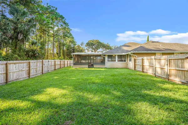 a view of a house with a yard and sitting area
