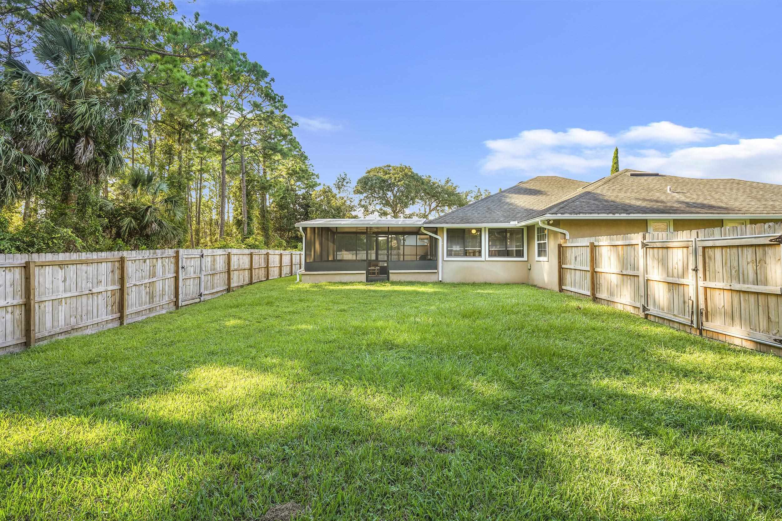 607 West Bianca Circle St. Augustine, FL 32086 - Photo 32 of 35 a view of a house with a yard and sitting area