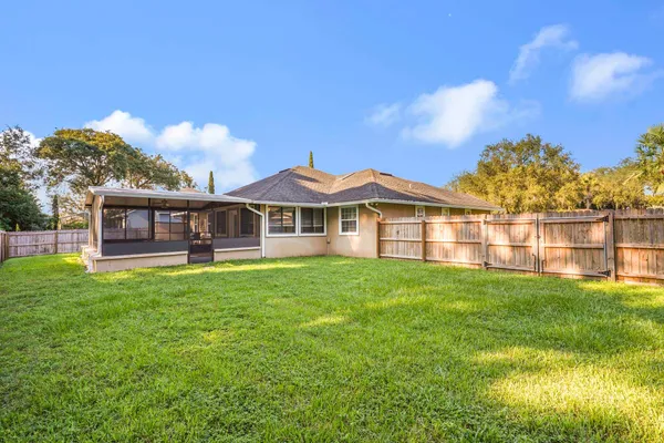 a front view of a house with yard and green space