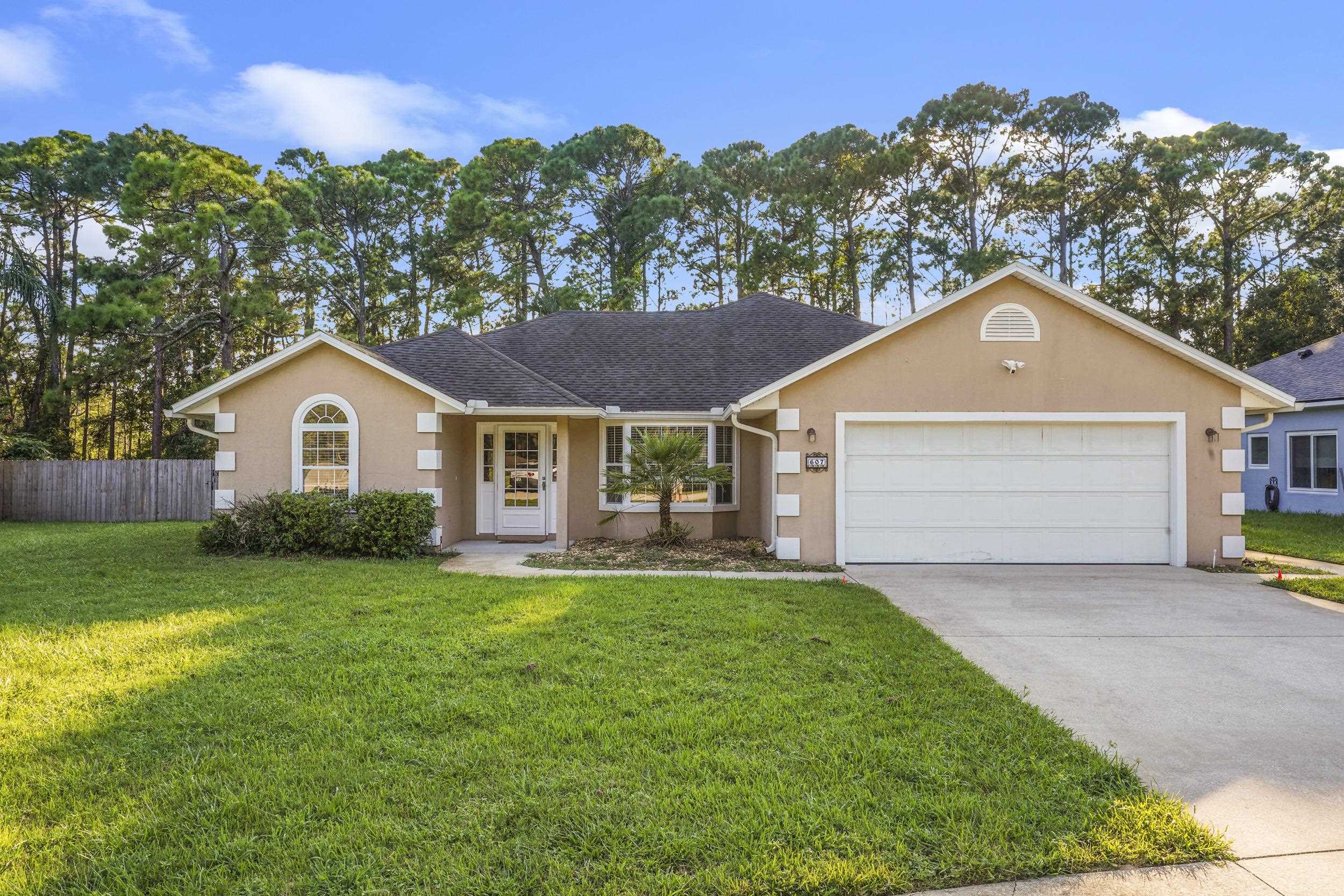607 West Bianca Circle St. Augustine, FL 32086 - Photo 35 of 35 a front view of a house with a yard and garage