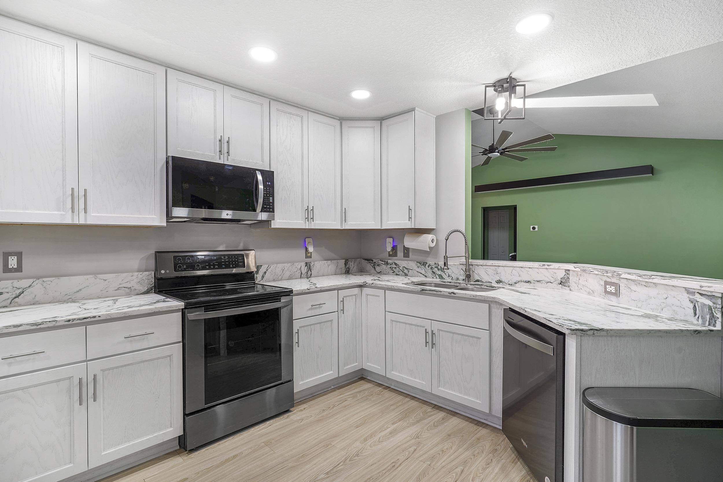 607 West Bianca Circle St. Augustine, FL 32086 - Photo 5 of 35 a kitchen with a sink stove and microwave