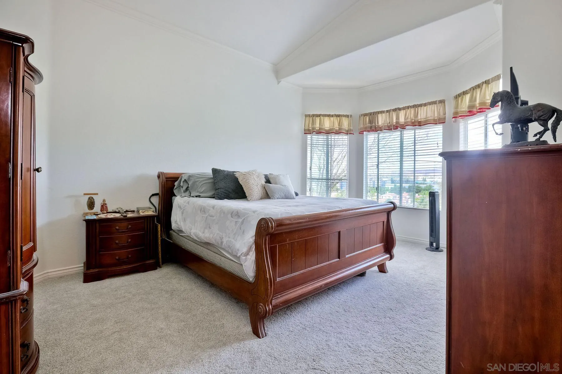 2479 Golfcrest Loop Chula Vista, CA 91915 - Photo 13 of 25 a bedroom with a bed and a dresser next to a window