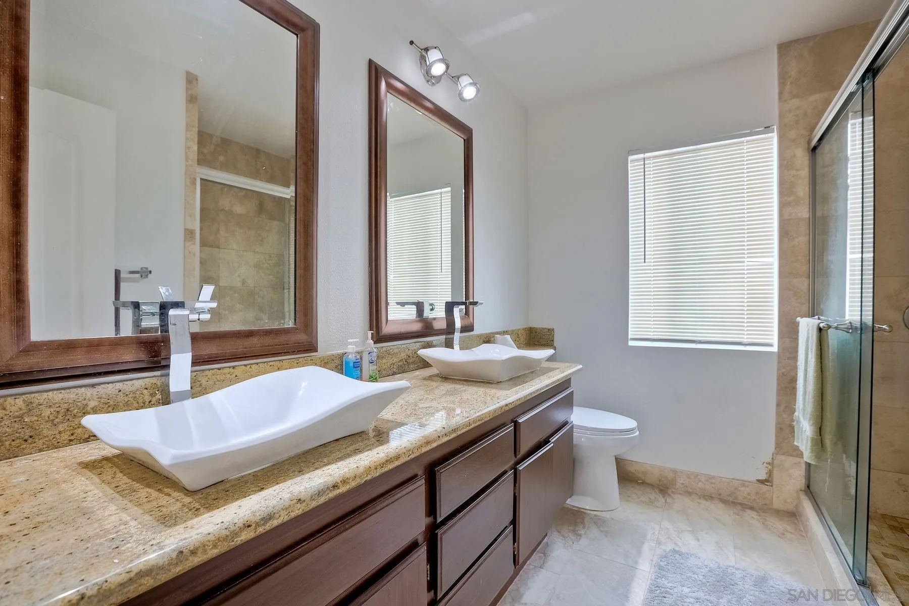 2479 Golfcrest Loop Chula Vista, CA 91915 - Photo 18 of 25 a bathroom with a granite countertop sink and a mirror