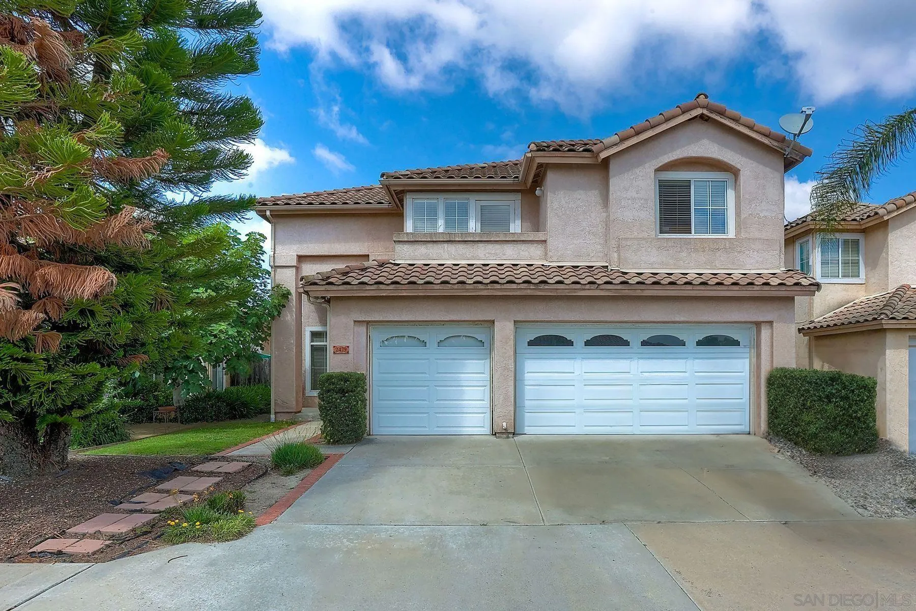2479 Golfcrest Loop Chula Vista, CA 91915 - Photo 2 of 25 a front view of a house with a yard and garage