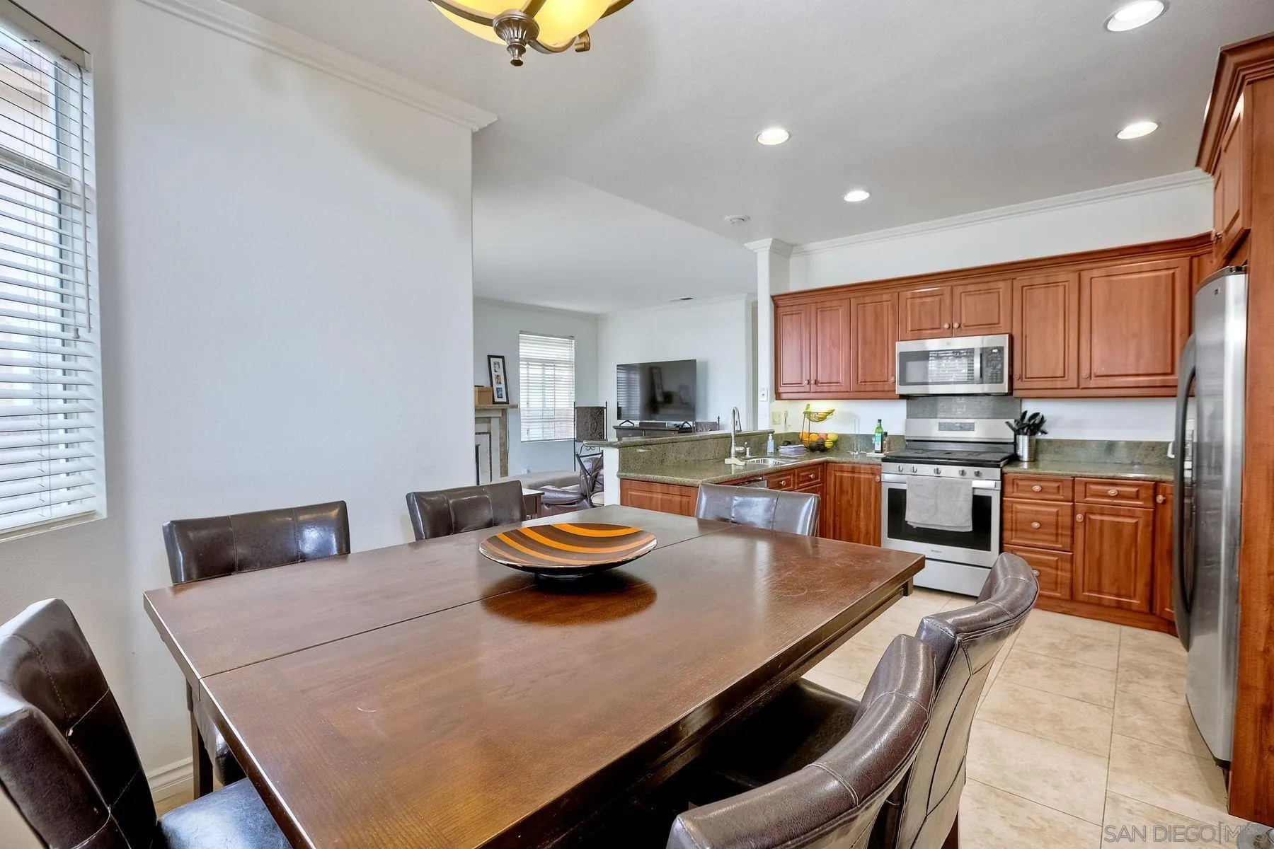 2479 Golfcrest Loop Chula Vista, CA 91915 - Photo 9 of 25 a kitchen with a sink a stove and chairs