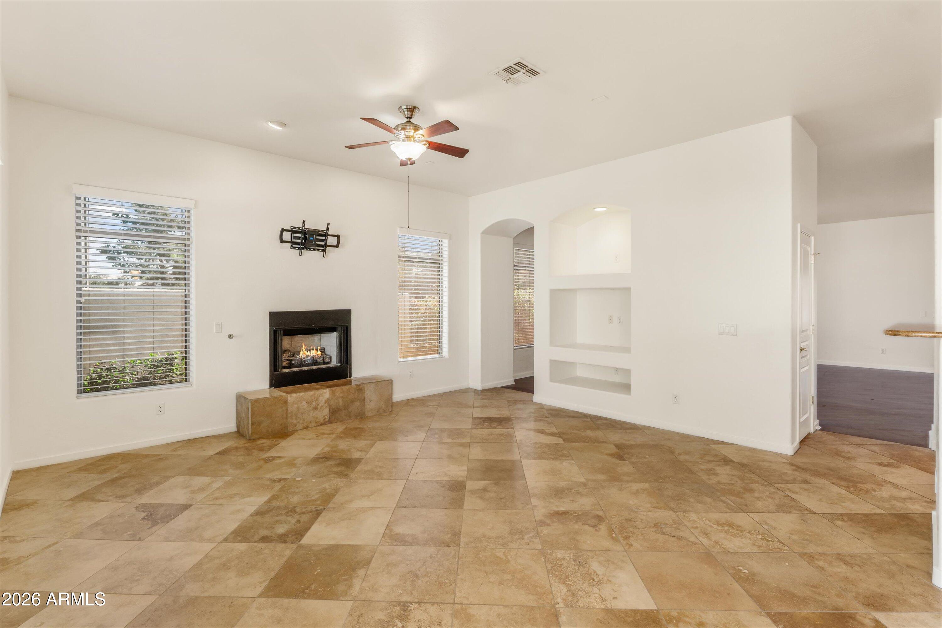 2130 East Beautiful Lane Phoenix, AZ 85042 - Photo 13 of 35 a view of an empty room with a fireplace and a window