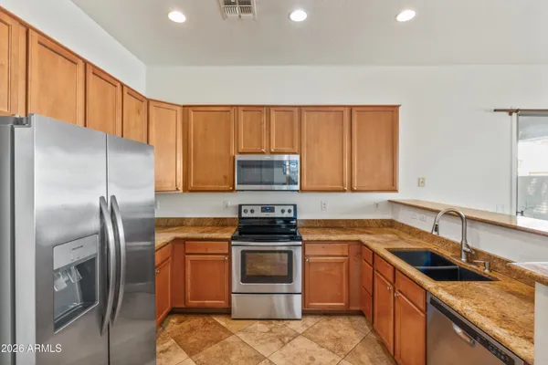 a kitchen with a sink stove and refrigerator