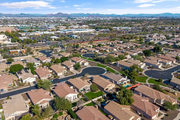 an aerial view of residential houses with outdoor space