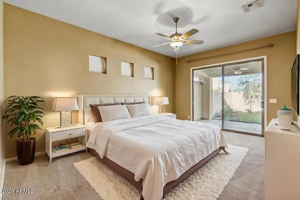 a spacious bedroom with a bed and a chandelier