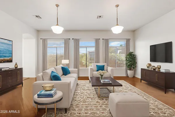 a living room with furniture a flat screen tv and a large window
