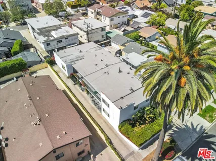 an aerial view of a residential houses with yard