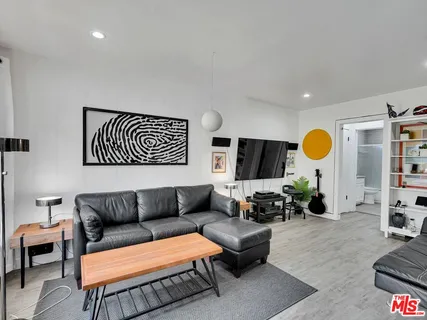 a living room with furniture a rug and a large window