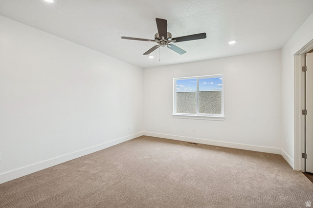 1627 North Angel Street Layton, UT 84041 - Photo 10 of 39 Empty room with light carpet, a ceiling fan, and recessed lighting