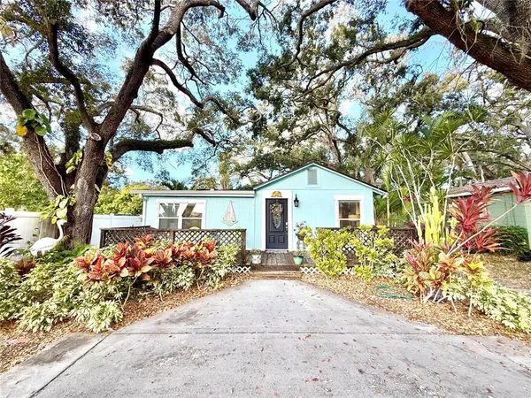 front view of a house with a tree
