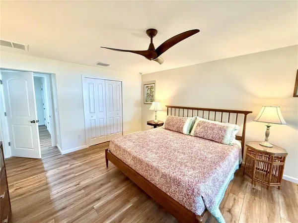 a bedroom with a bed dresser and a window