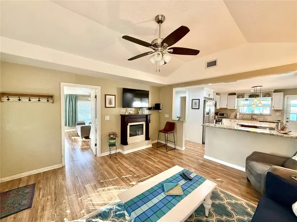a spacious bedroom with a bed and a flat screen tv