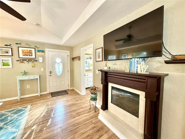 a kitchen with stainless steel appliances granite countertop a refrigerator a stove a sink a dining table and chairs