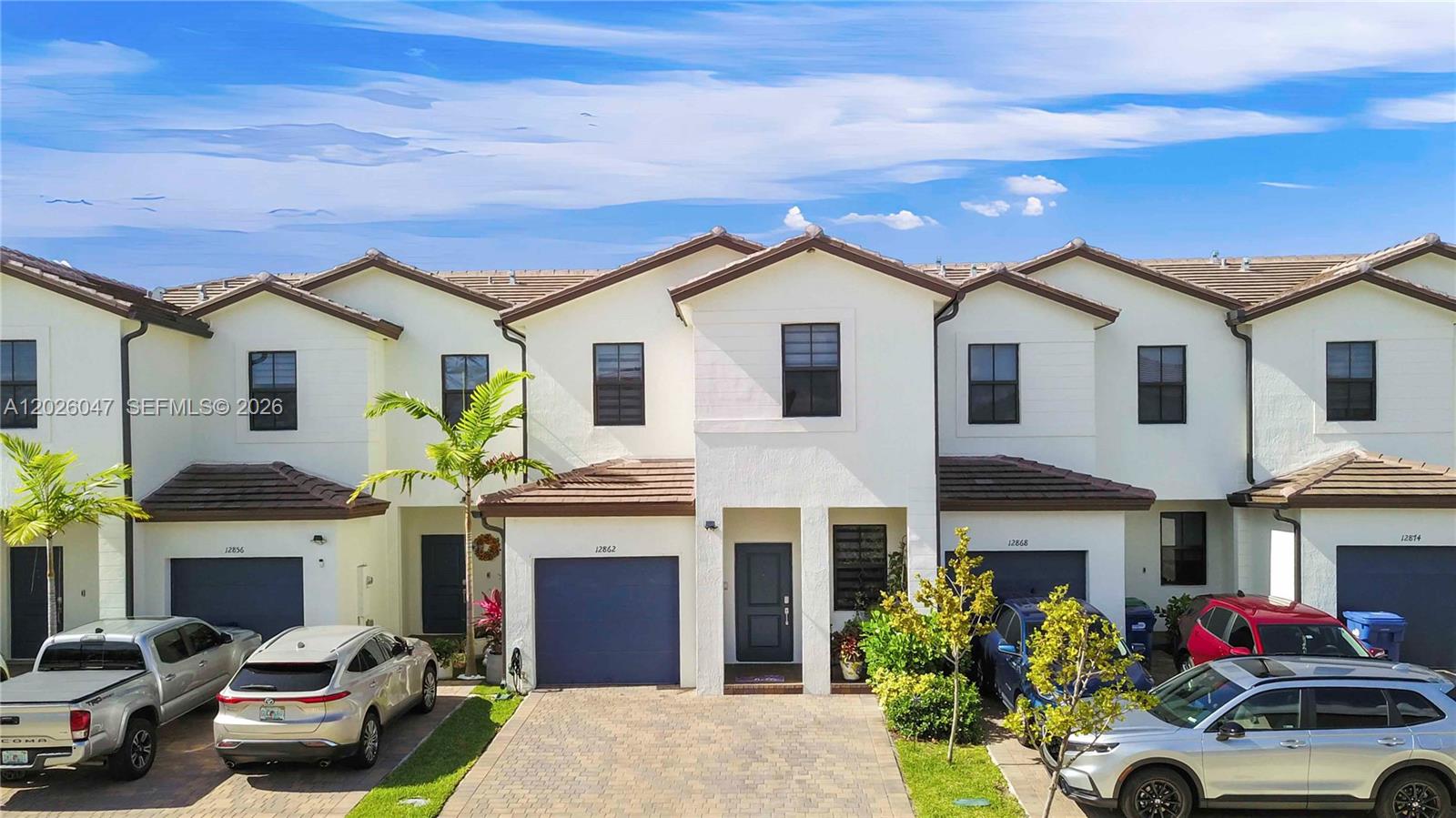 12862 Southwest 231st Street Miami, FL 33170 - Photo 2 of 30 a front view of a house with yard and parking
