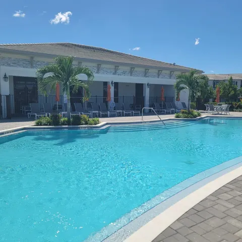 a front view of house with yard and outdoor seating