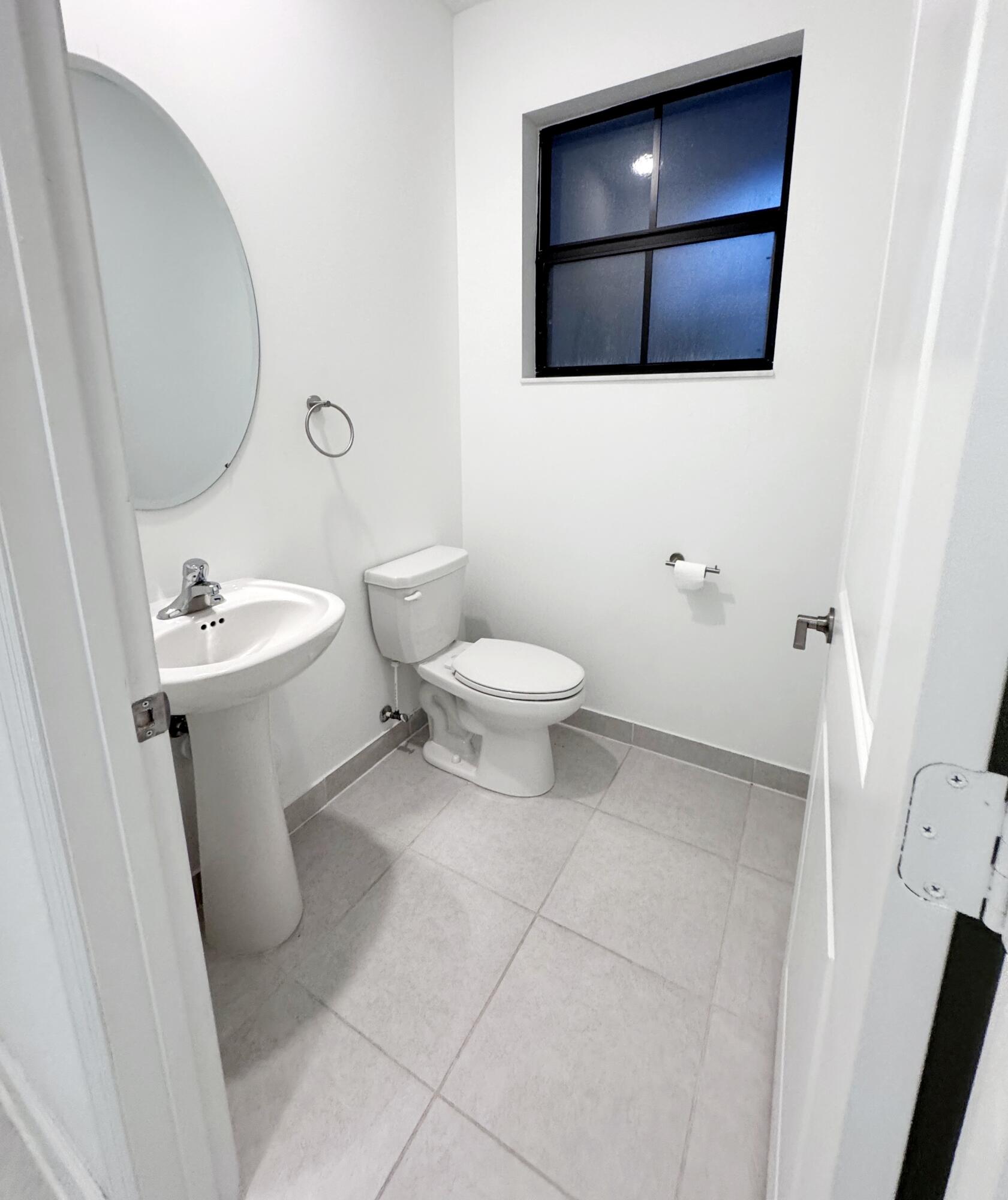 28706 Southwest 133rd Court Homestead, FL 33033 - Photo 12 of 40 a bathroom with a toilet sink and mirror