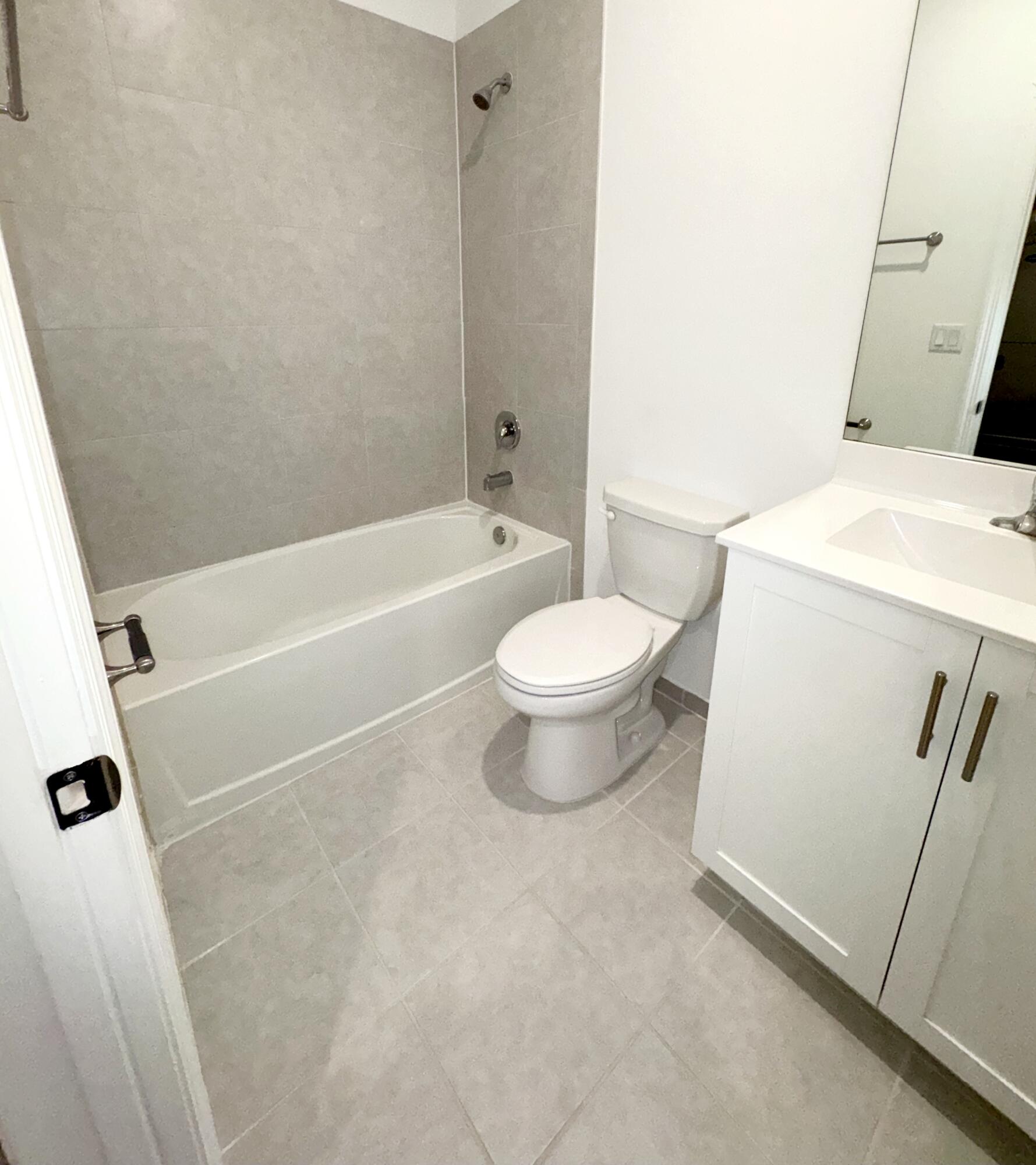 28706 Southwest 133rd Court Homestead, FL 33033 - Photo 21 of 40 a white toilet sitting next to a bath tub