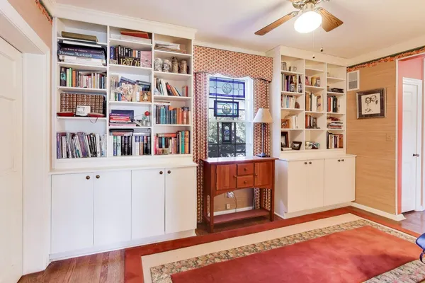 a room with a book shelf and a bookshelf