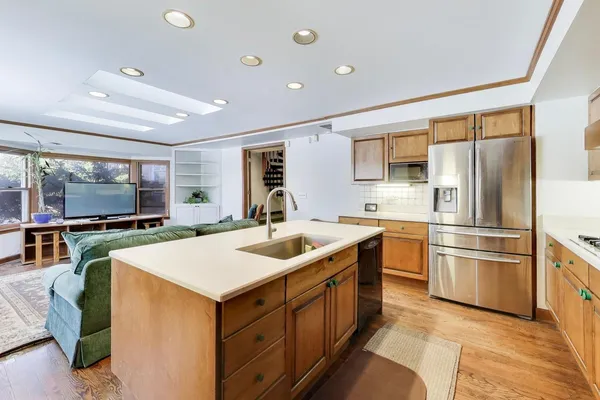 a kitchen with a sink and stainless steel appliances