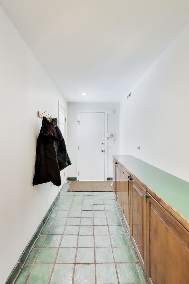 600 Riverwoods Road Mettawa, IL 60045 - Photo 27 of 49 a hallway with a black white checkered floor