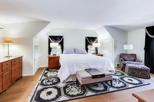 a bedroom with furniture and a rug