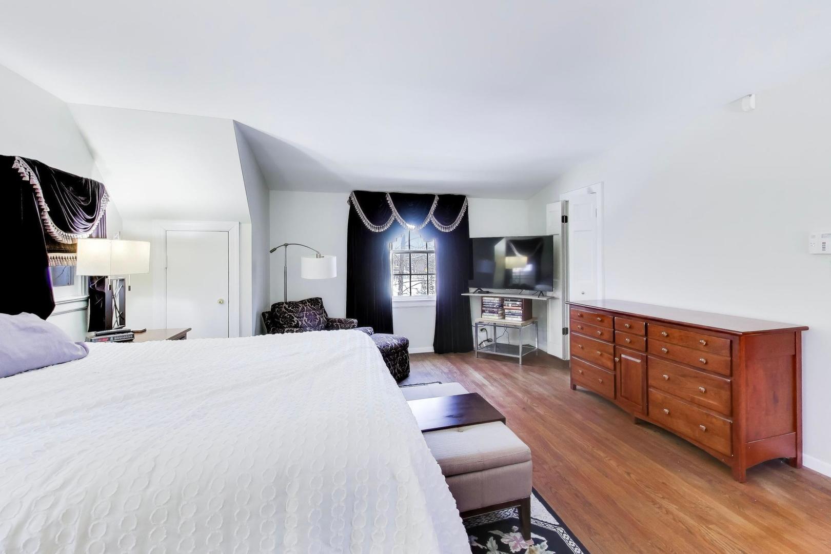 600 Riverwoods Road Mettawa, IL 60045 - Photo 31 of 49 a large bedroom with a bed and a large dresser in it