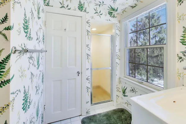 a view of a bedroom with a window and front door