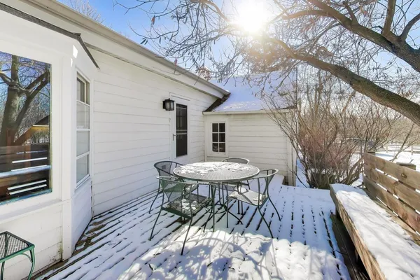 a view of a patio with table and chairs and wooden floor