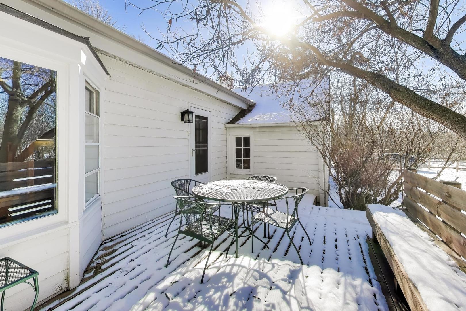 600 Riverwoods Road Mettawa, IL 60045 - Photo 6 of 49 a view of a patio with table and chairs and wooden floor