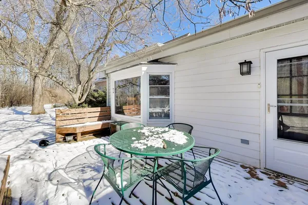 a backyard of a house with table and chairs