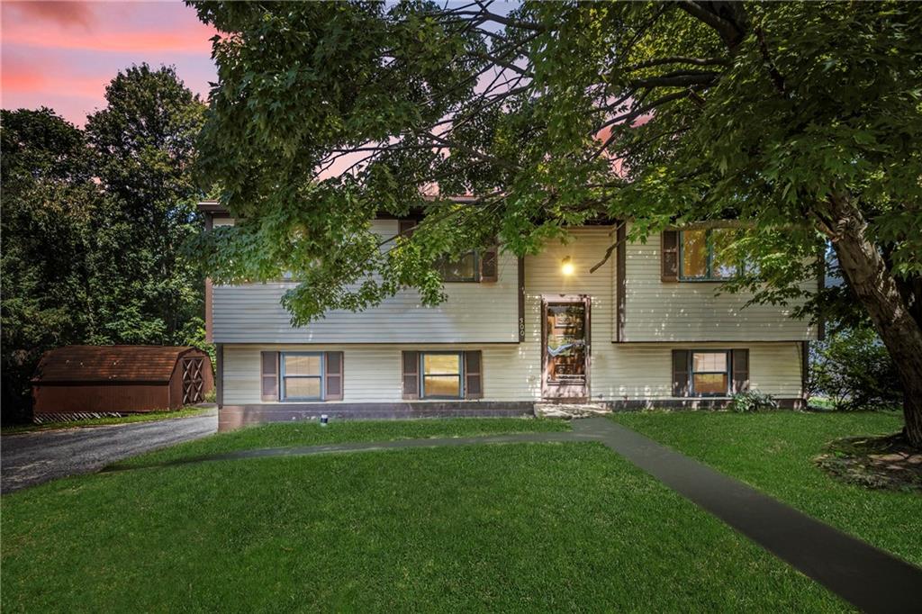 300 Moon Ridge Drive Freedom, PA 15042 - Photo 1 of 32 a front view of a house with a garden and yard