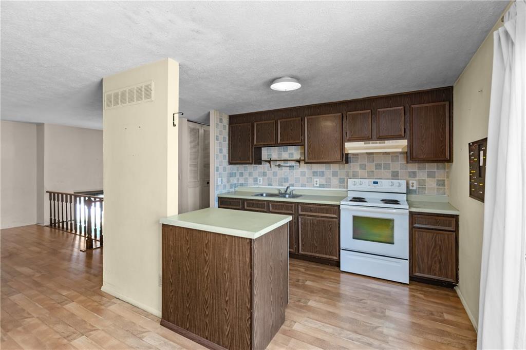300 Moon Ridge Drive Freedom, PA 15042 - Photo 11 of 32 a kitchen with a sink stove and refrigerator